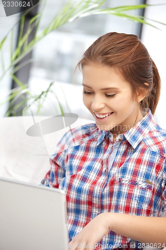 Image of happy woman with laptop computer