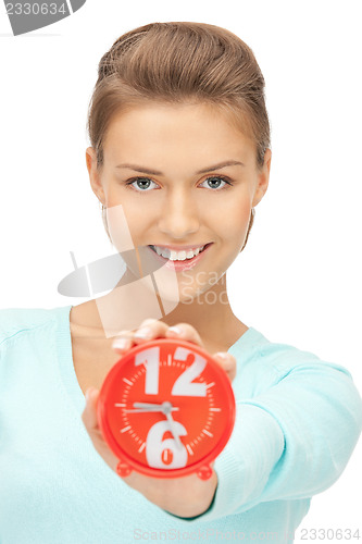 Image of woman holding alarm clock