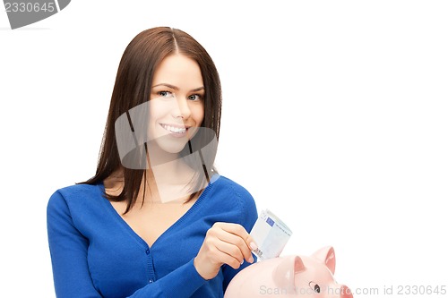 Image of lovely woman with piggy bank and money