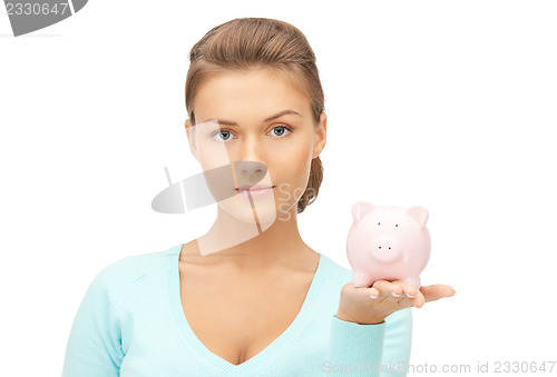 Image of lovely woman with piggy bank