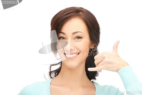 Image of woman making a call me gesture