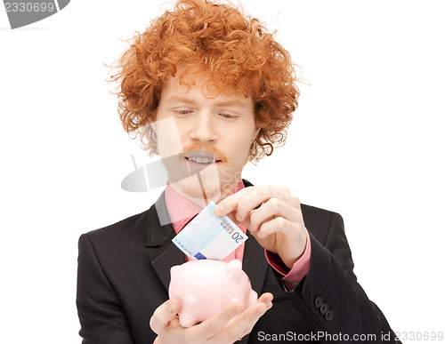 Image of man with piggy bank and money