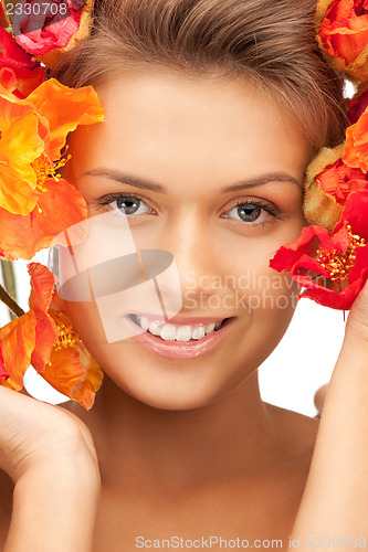 Image of lovely woman with red flowers