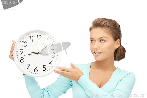 Image of woman holding big clock