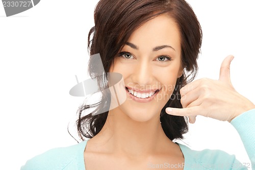 Image of woman making a call me gesture