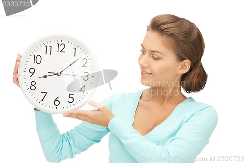 Image of woman holding big clock