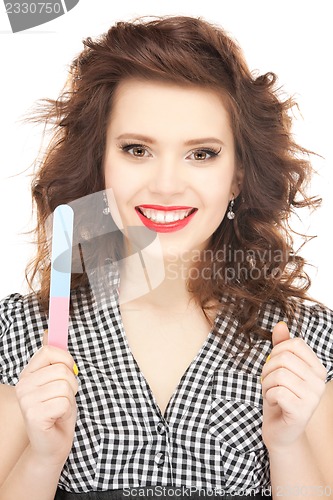 Image of beautiful woman polishing her nails