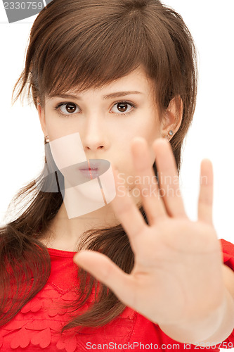 Image of teenage girl making stop gesture