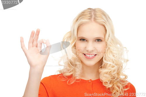 Image of lovely teenage girl showing ok sign