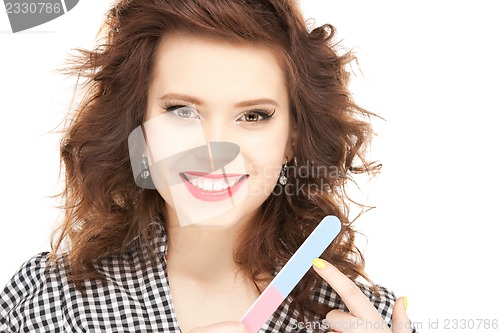 Image of beautiful woman polishing her nails