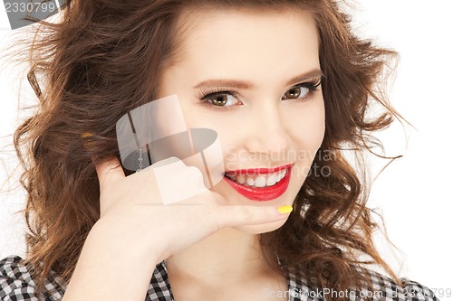 Image of woman making a call me gesture