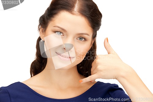 Image of woman making a call me gesture