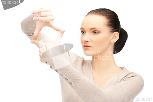 Image of lovely woman creating a frame with fingers