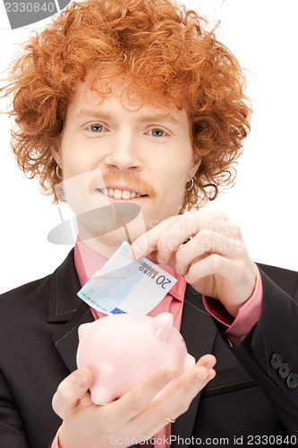 Image of man with piggy bank and money