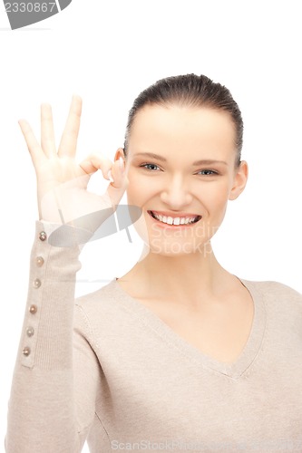 Image of lovely teenage girl showing ok sign