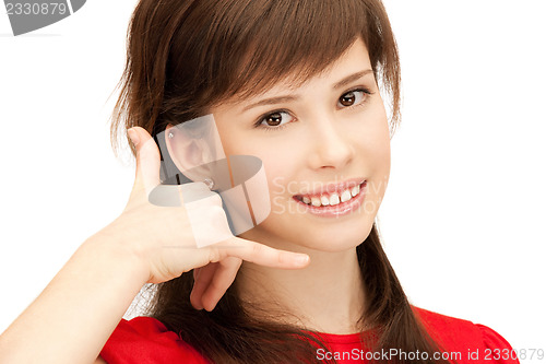 Image of teenage girl making a call me gesture