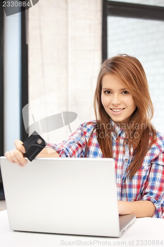 Image of happy woman with laptop computer and credit card