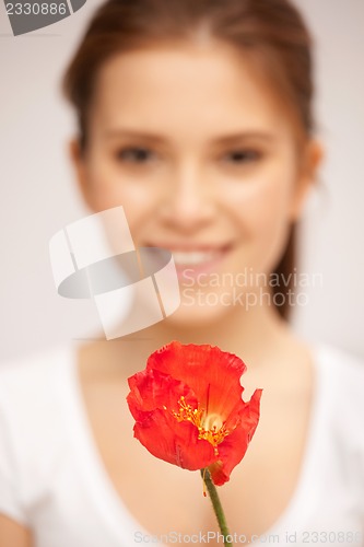 Image of beautiful woman with red flower