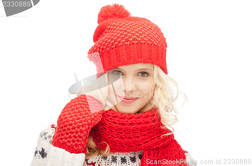 Image of beautiful woman in hat, muffler and mittens