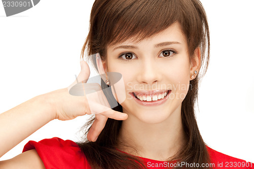 Image of teenage girl making a call me gesture