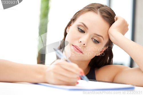 Image of calm woman with big notepad