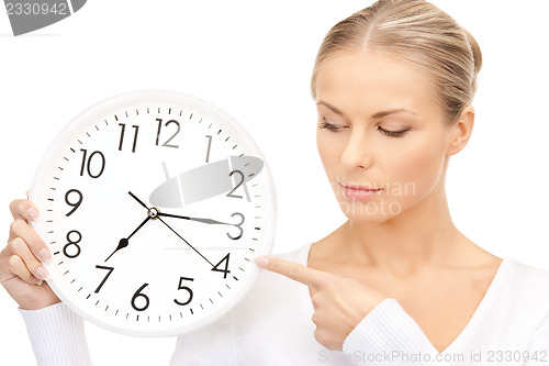 Image of woman holding big clock