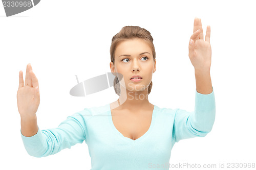 Image of businesswoman working with something imaginary