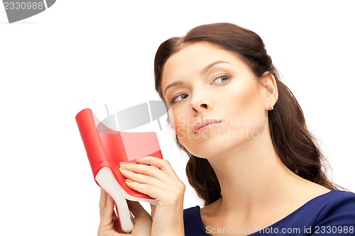 Image of calm and serious woman with book