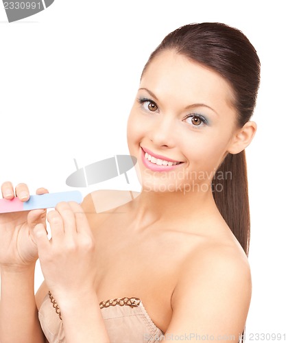 Image of beautiful woman polishing her nails