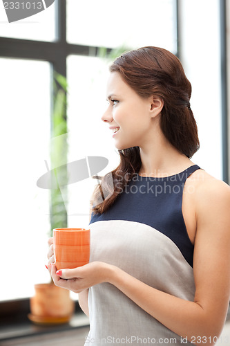 Image of lovely businesswoman with mug