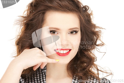 Image of woman making a call me gesture