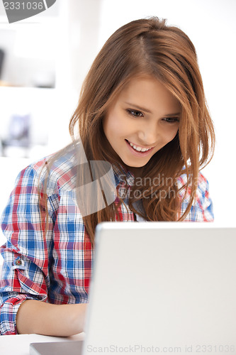 Image of happy woman with laptop computer