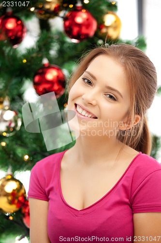 Image of happy and smiling woman with christmas tree