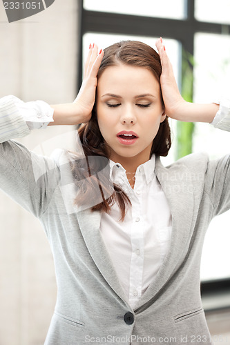 Image of woman with hands on ears
