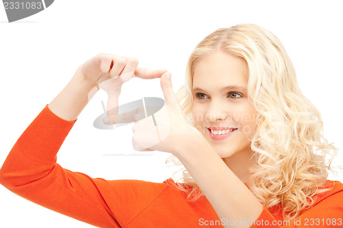 Image of lovely woman creating a frame with fingers