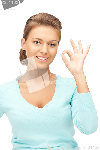 Image of lovely teenage girl showing ok sign