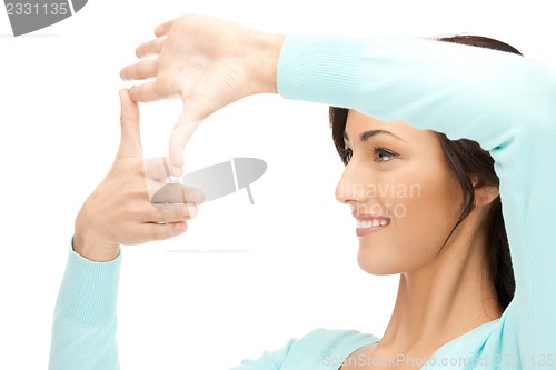 Image of lovely woman creating a frame with fingers