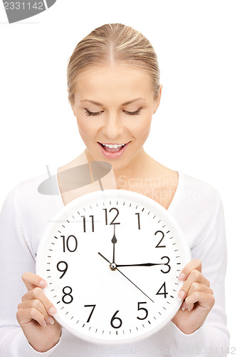 Image of woman holding big clock