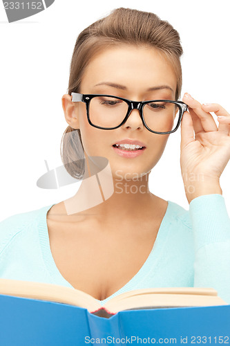 Image of calm and serious woman with book