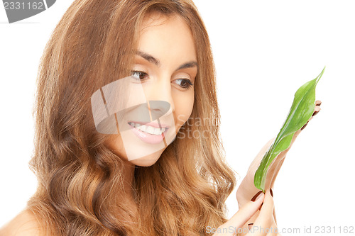 Image of woman with green leaf