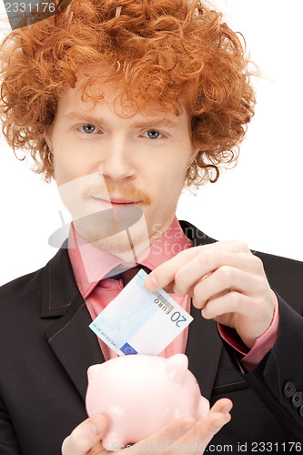 Image of man with piggy bank and money