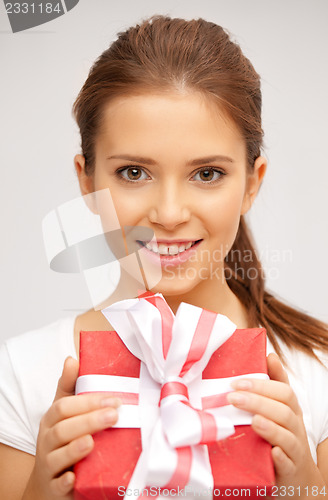 Image of happy teenage girl with gift box