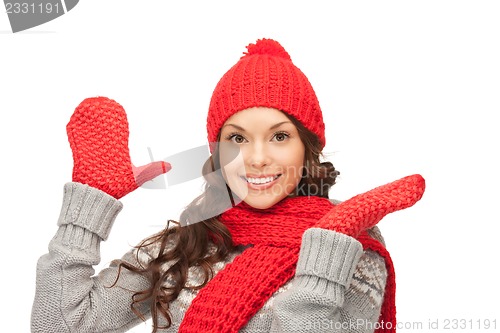 Image of beautiful woman in hat, muffler and mittens