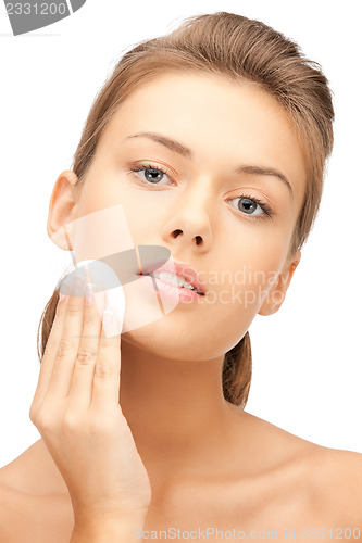 Image of beautiful woman with cotton pad