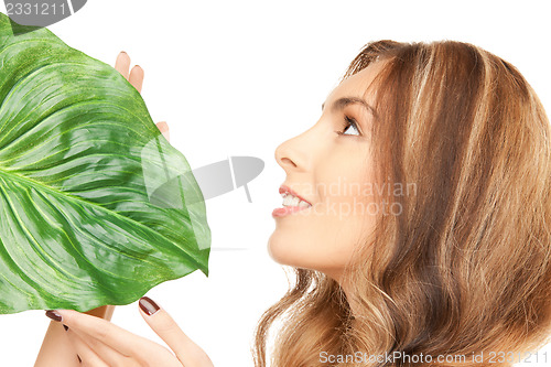 Image of woman with green leaf