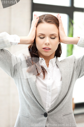 Image of woman with hands on ears