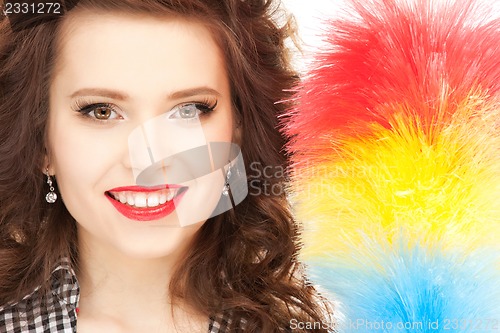 Image of beautiful woman with cleaning sweep