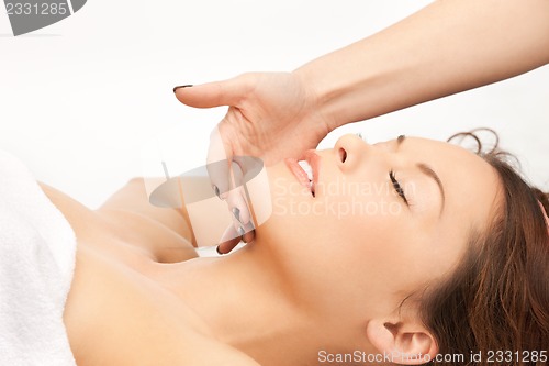 Image of beautiful woman in massage salon