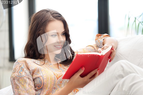Image of happy and smiling woman with book
