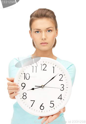 Image of woman holding big clock